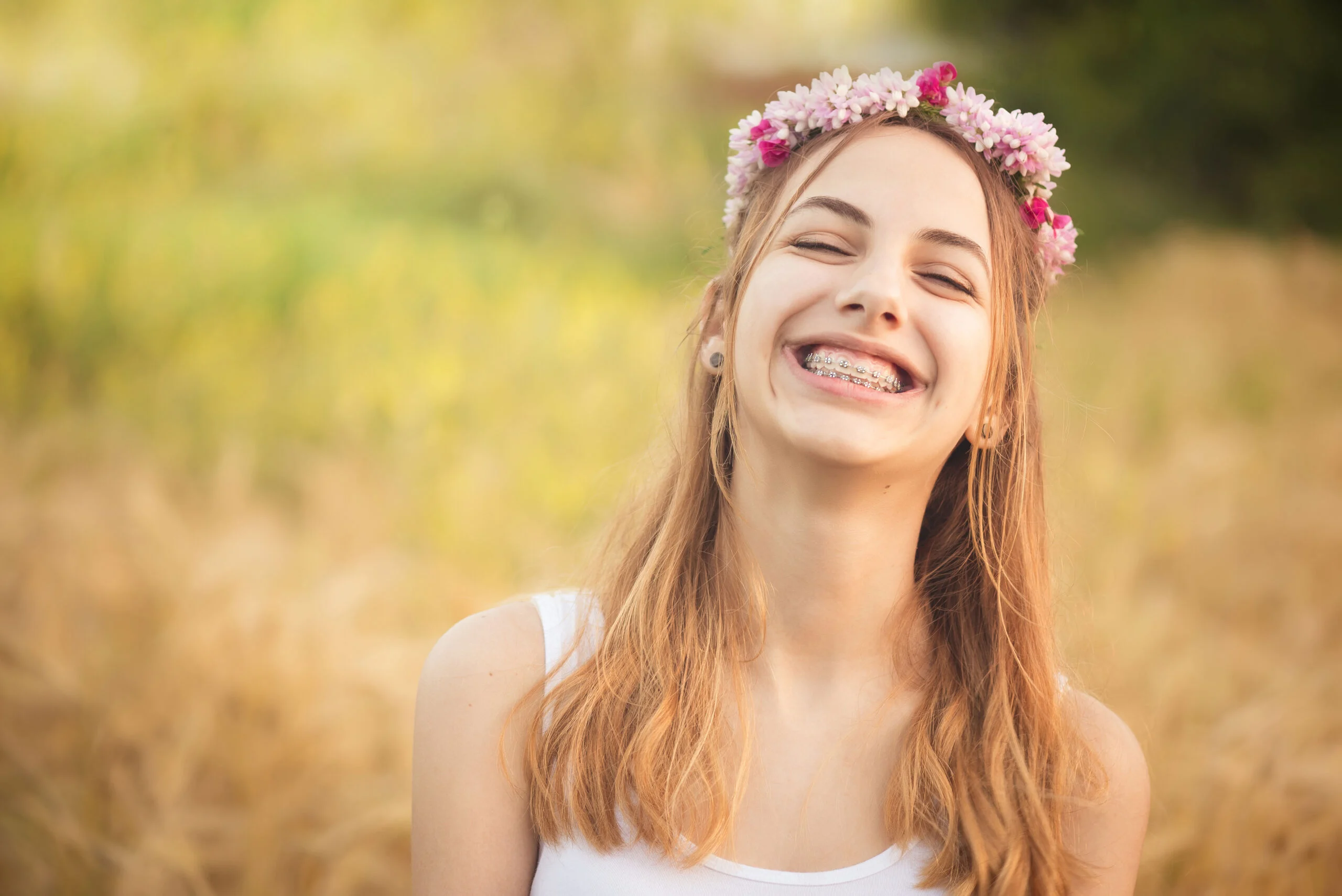 Ortho young girl with braces in the summer