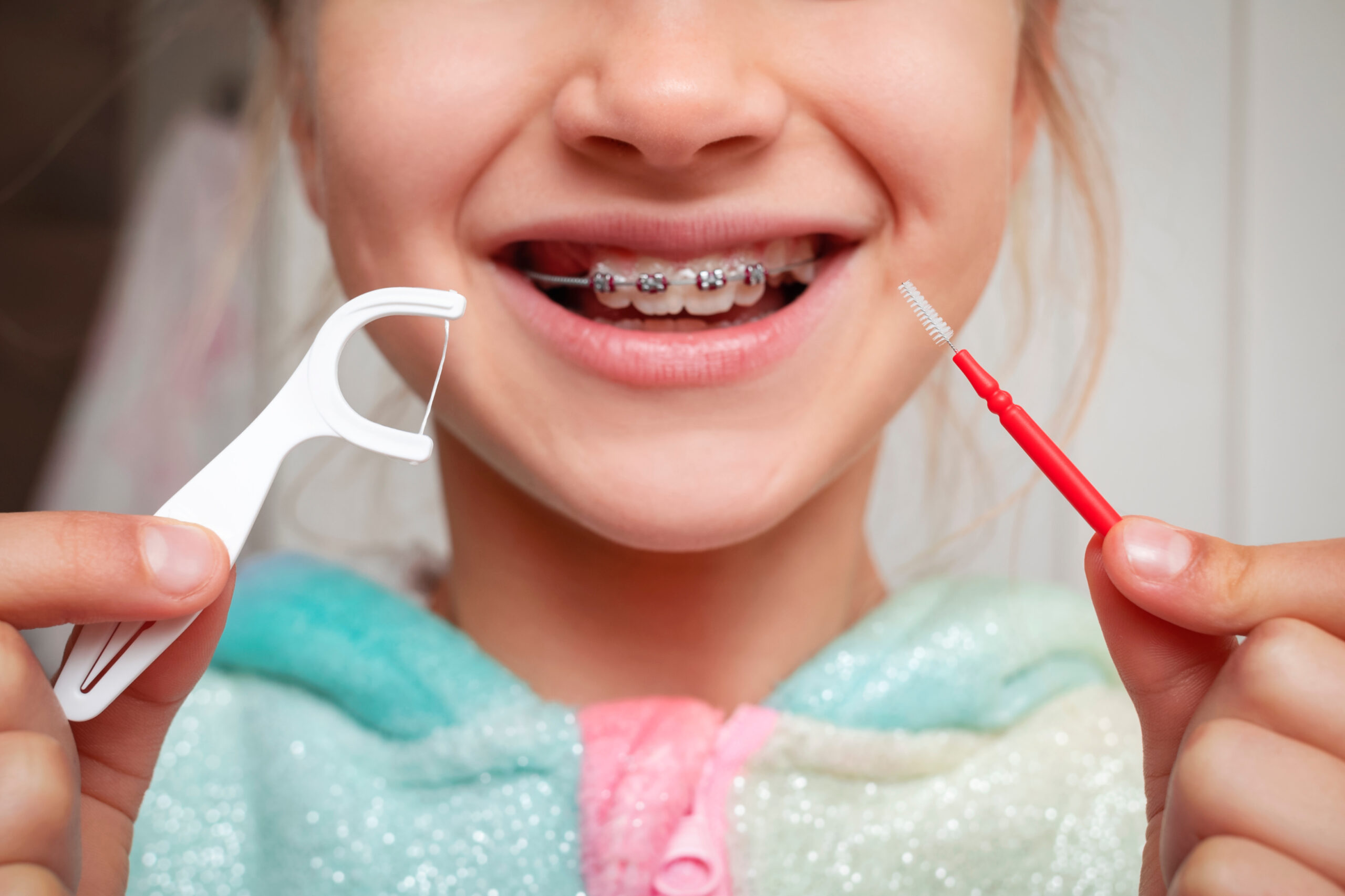 Brace Cleaning Teeth for Kids. Child Clean Teeth with Braces. Dental Braces Care in Children, Flossing and Brushing.
